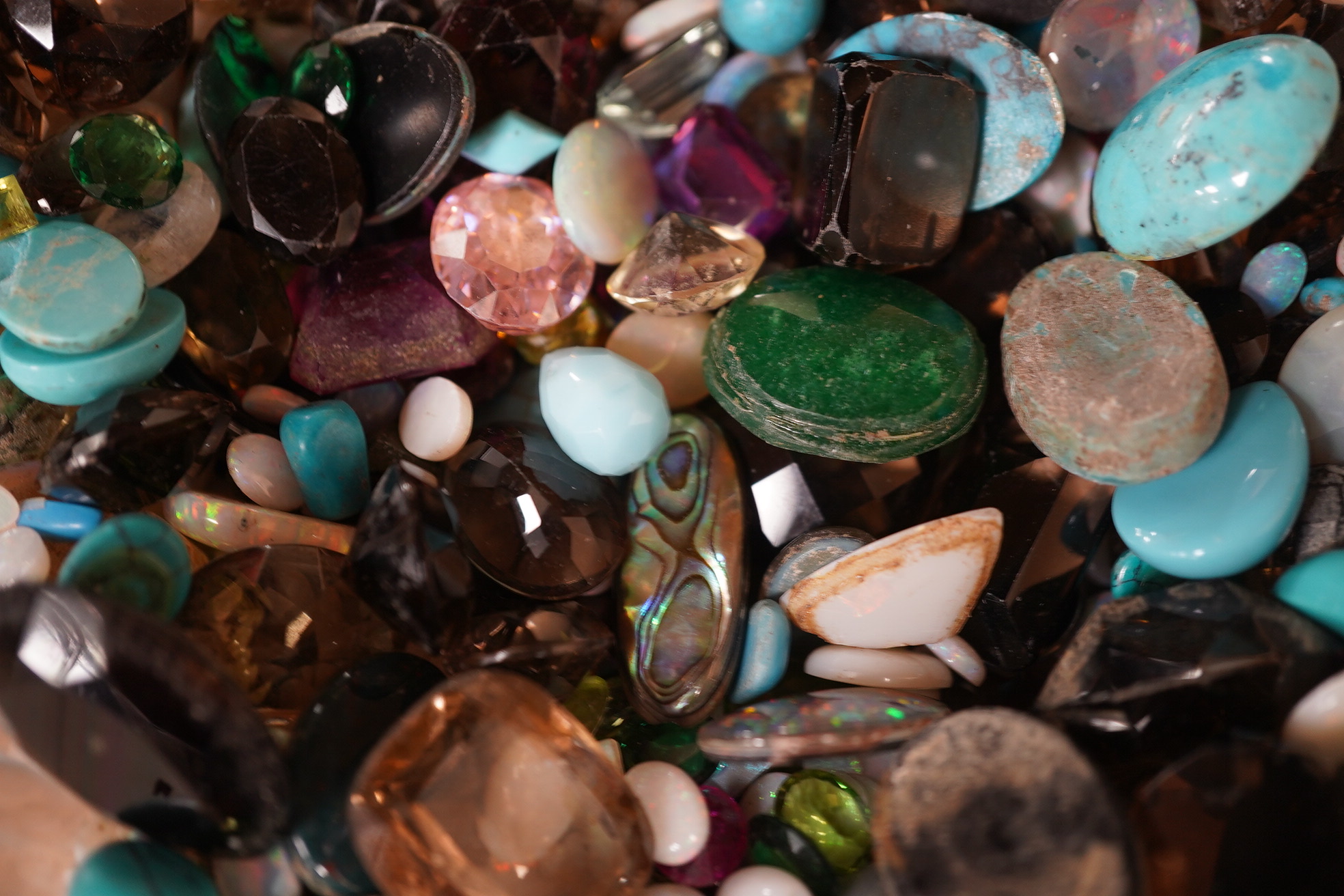 A large quantity of assorted unmounted cut and cabochon gemstones etc, including opal, quartz and turquoise. Condition - poor to fair to good